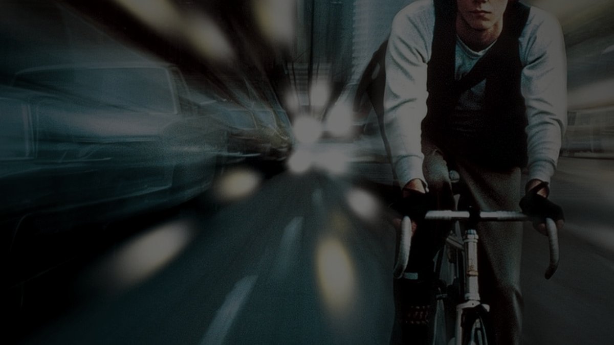 Still from Quicksilver (1986) — tmdb backdrop; genuine film still. baked through scripts/bake_dark_photo.py at factor 0.45, 1200x675