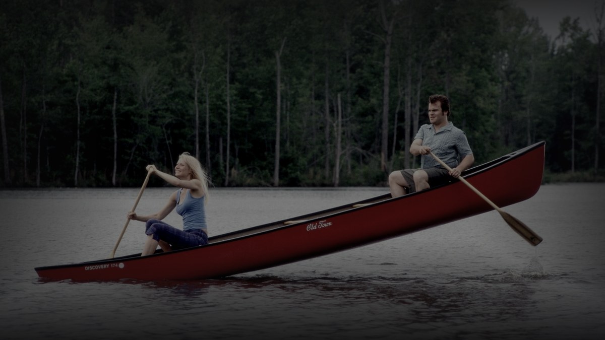 Still from Shallow Hal (2001) — tmdb backdrop (id 9889); genuine film still of hal and rosemary. baked through scripts/bake_dark_photo.py at factor 0.45, 1200x675